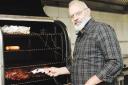 HOT STUFF: Owner Paul Bradley gets down to hard work at the smoker