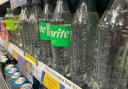 Labelled and label-less bottles of Sprite in Tesco Express in Western Road, Brighton