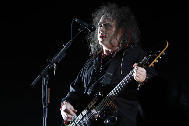 Robert Smith, lead vocalist and guitarist for the English band The Cure performs during the last stop of the band's tour through Latin America in Mexico City, Sunday, April 21, 2013. (AP Photo/Marco Ugarte)