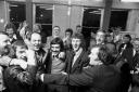 Carlisle United players and staff celebrate in the Cumberland Newspapers officers as news of their promotion comes through