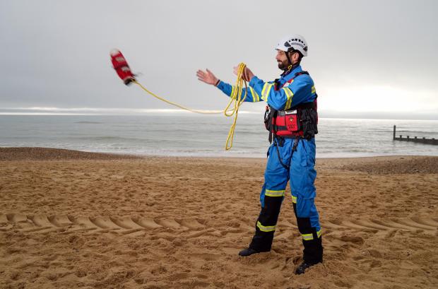 Redhill And Reigate Life: HM Coastguard Coastal Operations Area Commander Tom Wright casts a throwline on Southbourne beach in Dorset (PA)